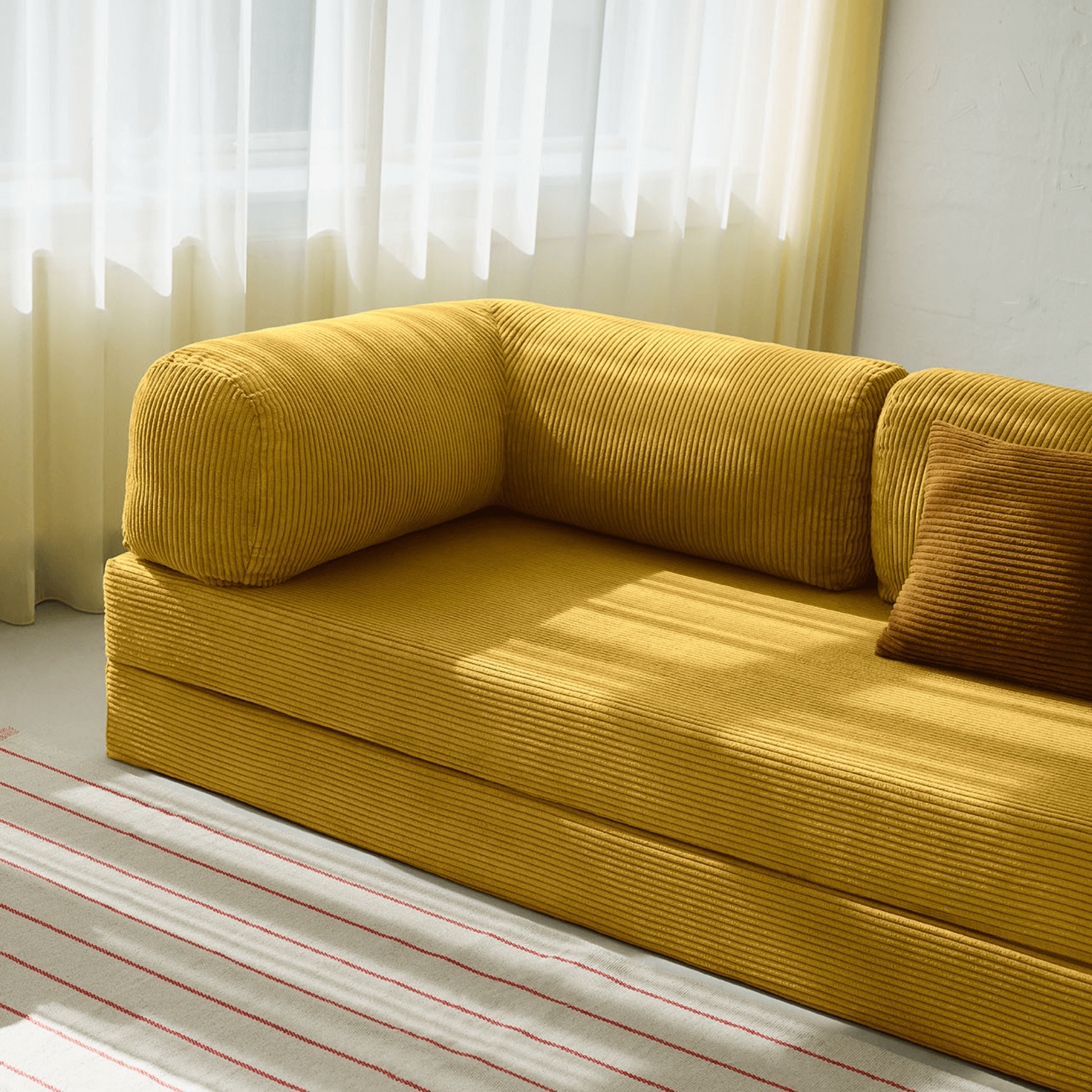 Primyhome Ginger Yellow corduroy convertible sofa bed in a sunlit living room with minimalist decor and boho wall art