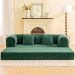 Primyhome Modern convertible green corduroy floor sofa bed in a cozy living room setting with a wooden floor lamp and framed botanical art.
